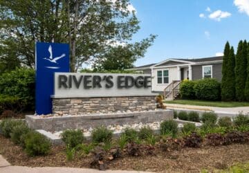River's Edge community monument sign with heron logo.