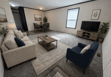 A modern living room with a beige sofa, navy armchair, coffee table, TV on a wooden stand, and a dining table with chairs in the back. Neutral colors and simple decor create a cozy, minimalist atmosphere.